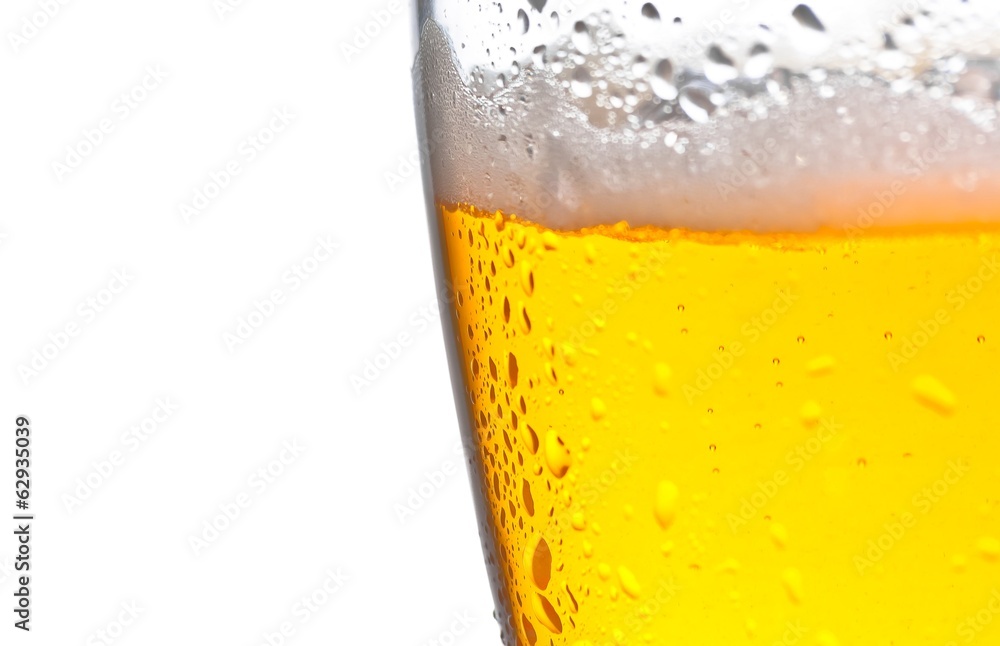 detail of glass of fresh beer with drops on white background detail of glass of fresh beer with drops on white background