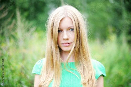 Beautiful young girl posing outdoors in a forest