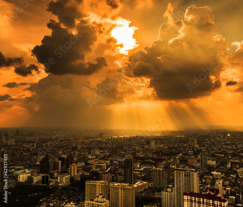 Rays of light shining through dark clouds in Bangkok of Thailand