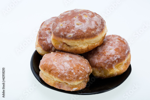 whole donuts on the black porcelain plate