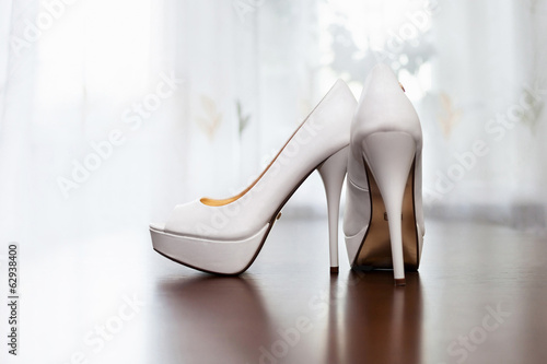 white wedding shoes for women on the floor