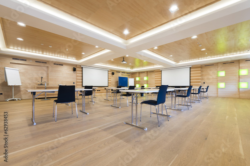 flipchart and projection screens in wooden conference room photo
