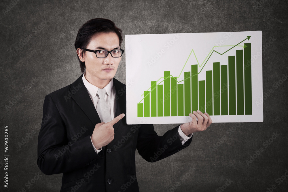 Businessman with chart of profits Businessman with chart of profits