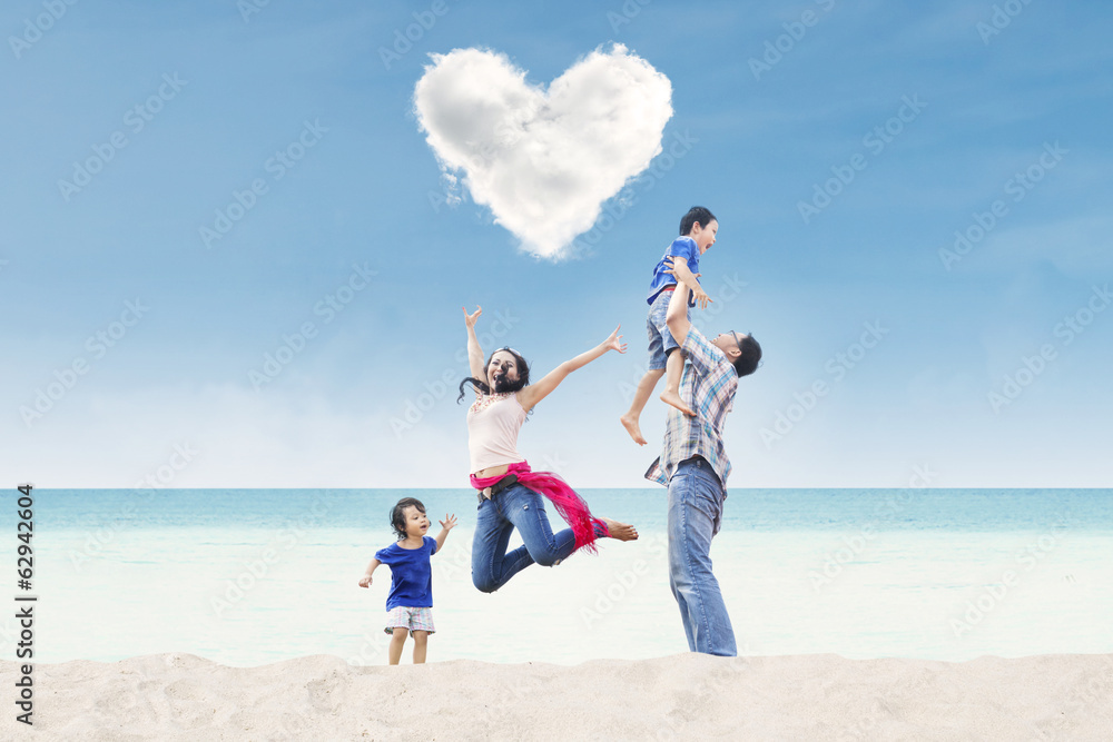 Happy family under heart cloud at beach Happy family under heart cloud at beach