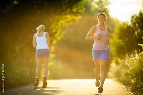 Young woman running outdoors on a lovely sunny summer evening