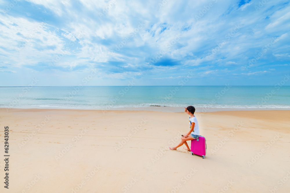 Woman with a suitcase on the beach Woman with a suitcase on the beach