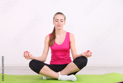 Young beautiful fitness girl exercising in gym