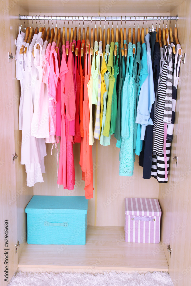 Colorful clothes hanging in wardrobe Colorful clothes hanging in wardrobe