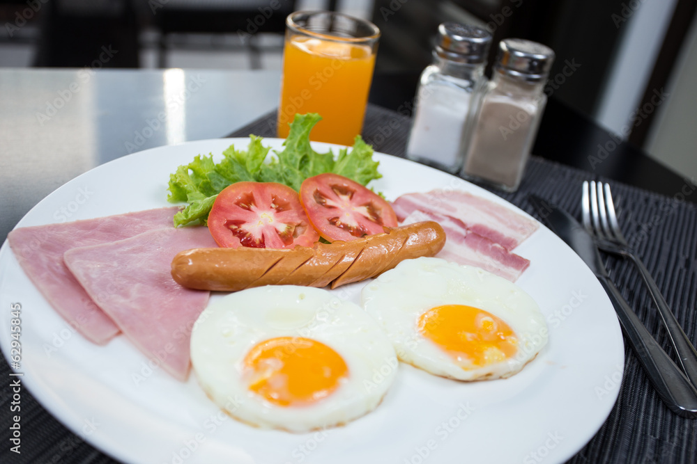 American breakfast with eggs ham bacon and sausage American breakfast with eggs ham bacon and sausage