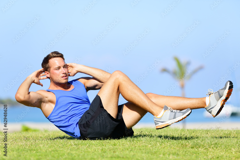 Sit ups - fitness man exercising sit up outside Sit ups - fitness man exercising sit up outside