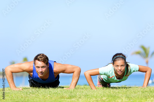 Sport fitness couple doing push ups