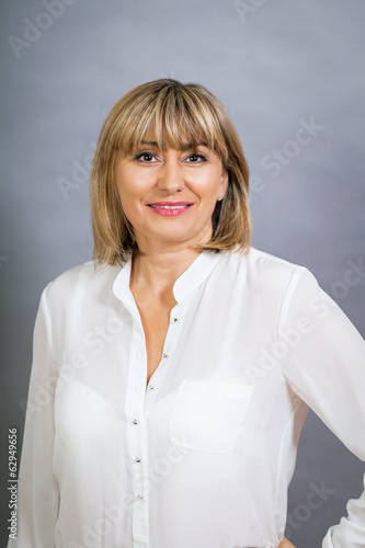 Fotografie Smiling confident middle-aged blond woman