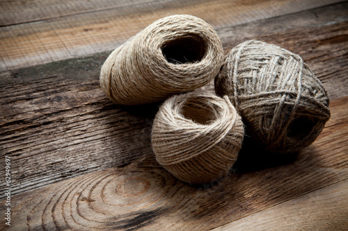 Three rope coils on old wooden background