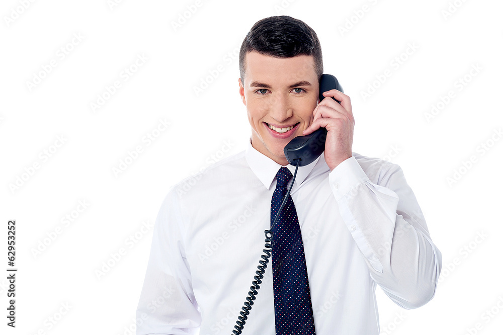 Young professional answering phone call Young professional answering phone call