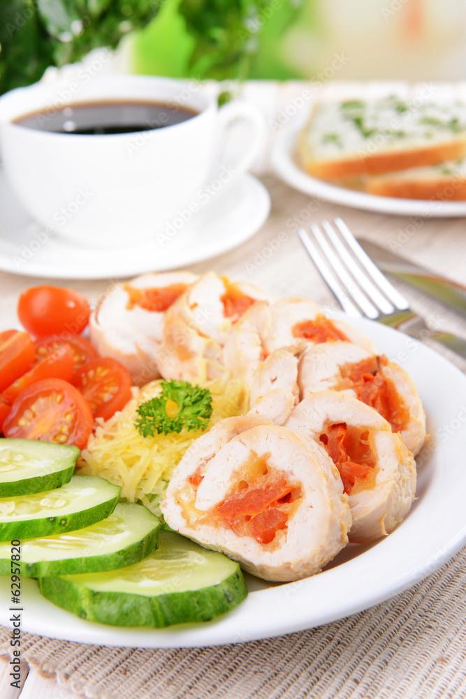 Delicious chicken roll on plate on table close-up Delicious chicken roll on plate on table close-up
