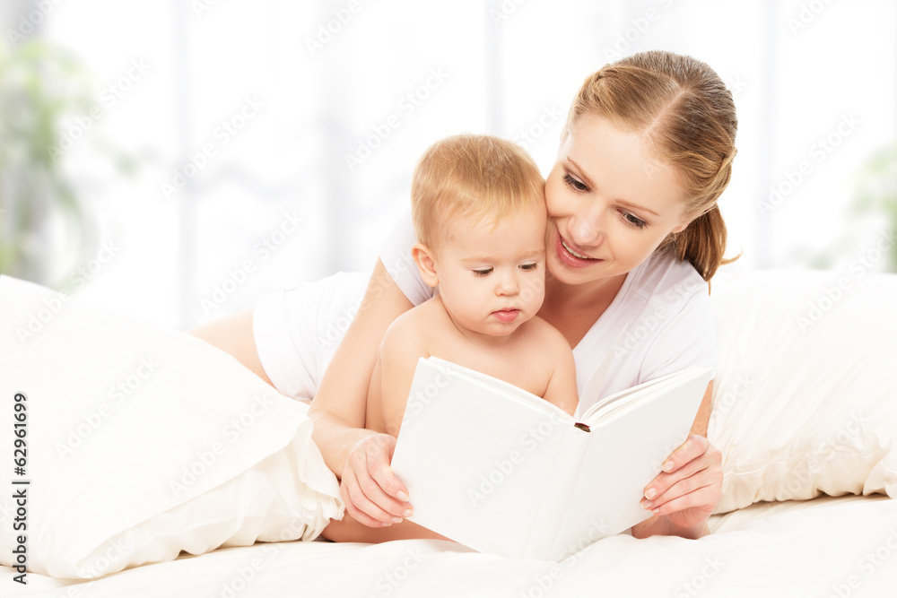 Mother reading book baby in bed before going to sleep Mother reading book baby in bed before going to sleep