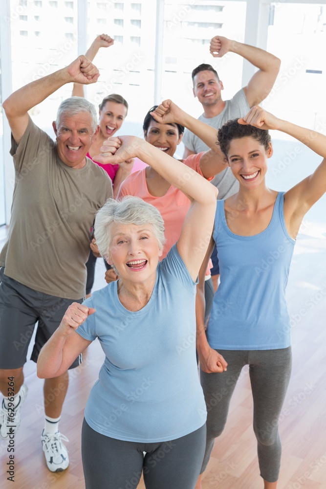 Portrait of smiling people doing power fitness exercise