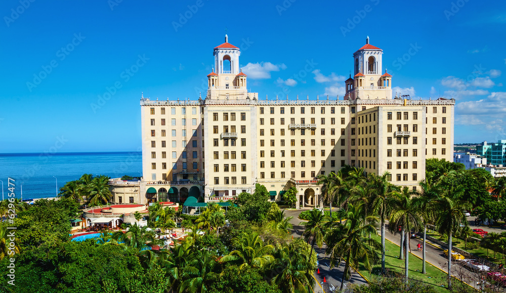 View of Hotel Nacional among green palm trees in Havana. Cuba