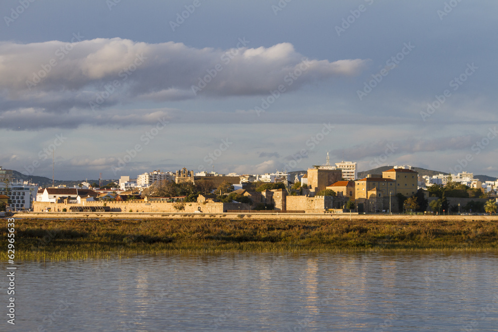 Fototapeta premium city of Faro, Portugal, creating a reflection on the water.