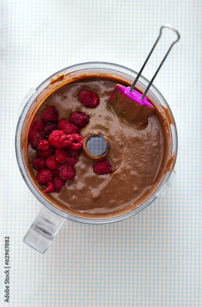 Making Cake - Mixing chocolate batter with raspberries Making Cake - Mixing chocolate batter with raspberries