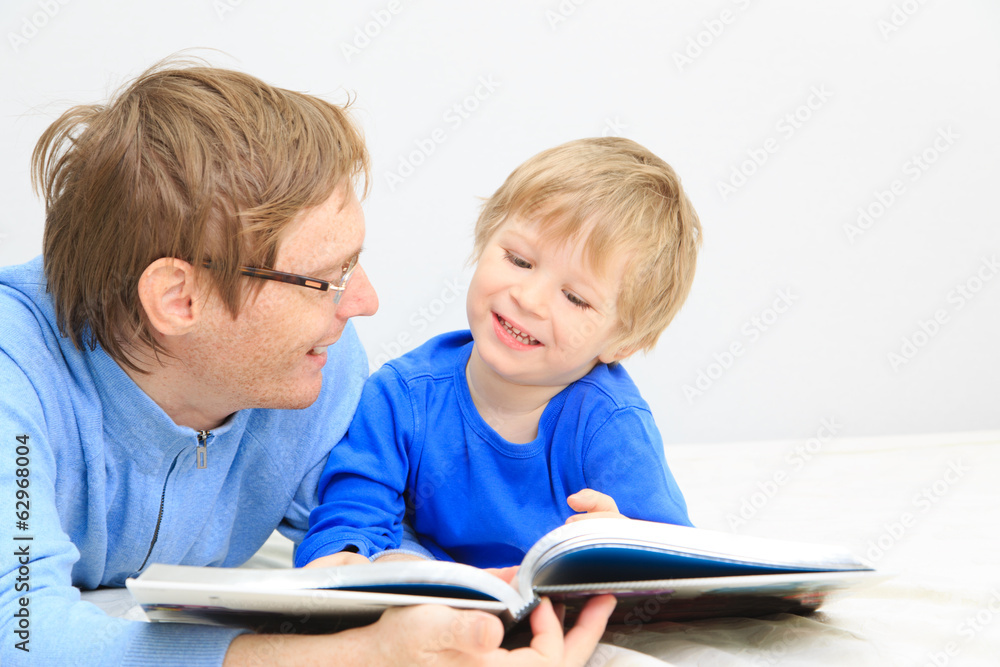 Father and son reading together Father and son reading together