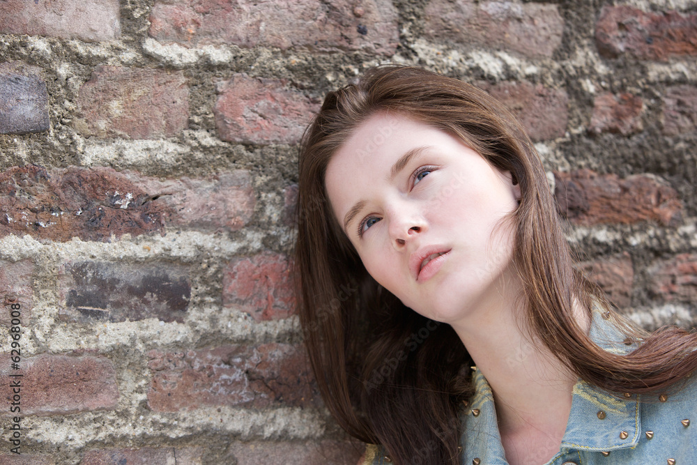 Model posing against brick wall Model posing against brick wall
