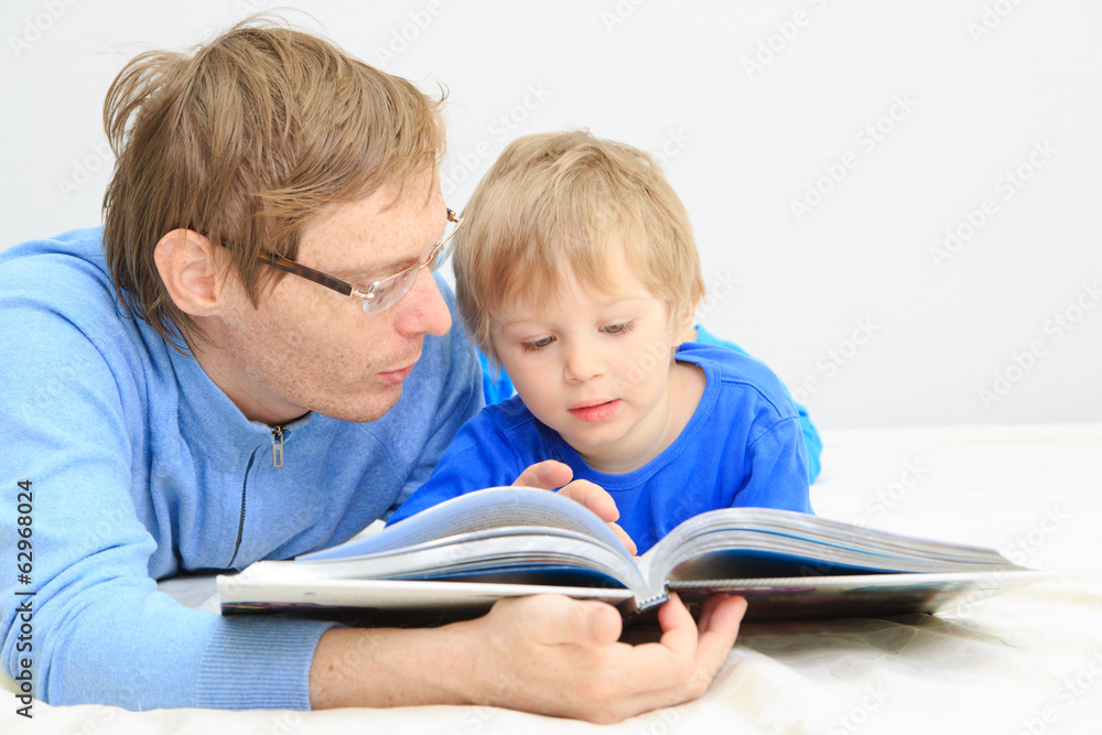 Father and son reading together Father and son reading together