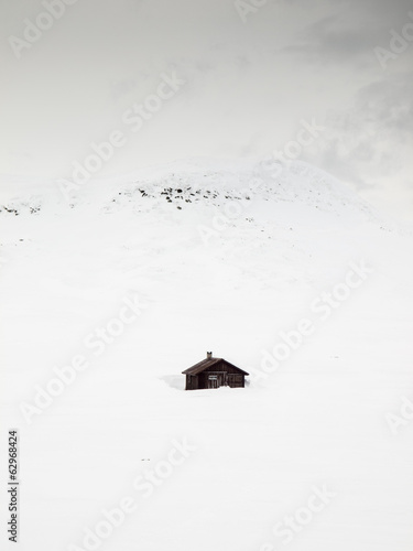 mountain huts in snow storm photo