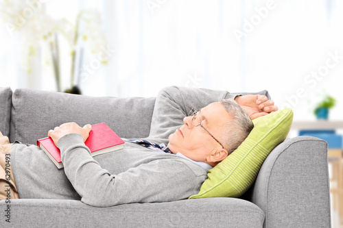 Senior man sleeping on sofa