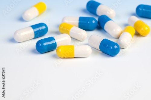 Colorful medical capsules on white background.