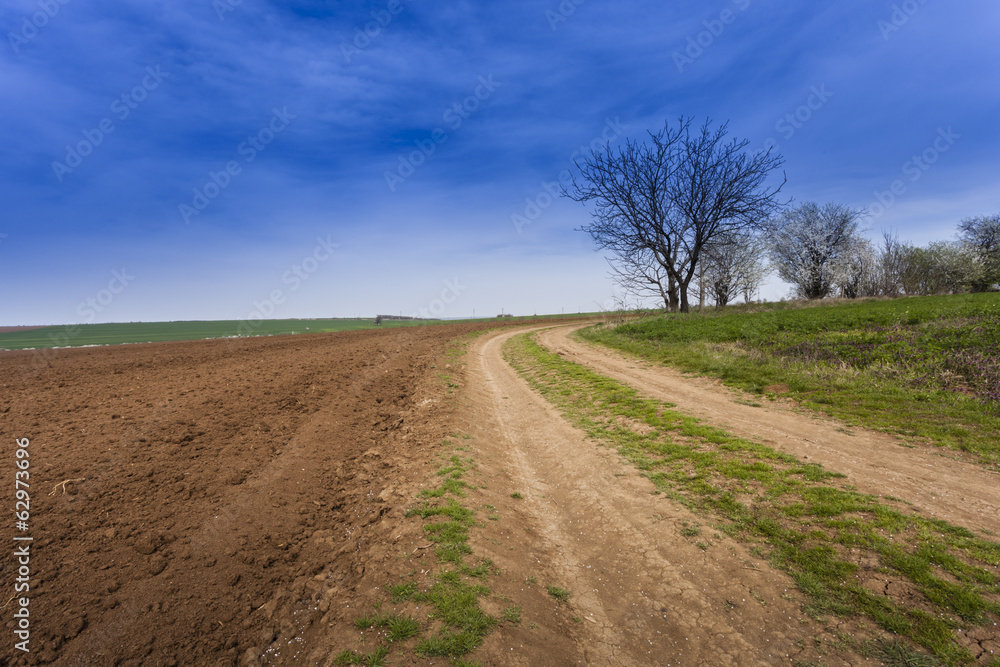 Ploughed field under deep blue sky with clouds Ploughed field under deep blue sky with clouds