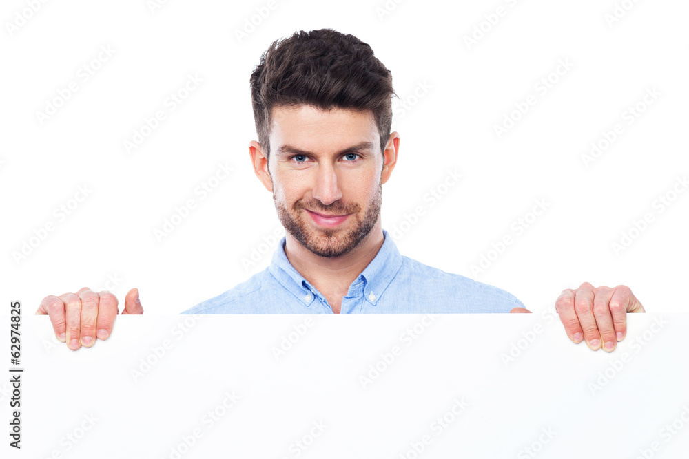 © pikselstock - Young man with blank poster © pikselstock - Young man with blank poster