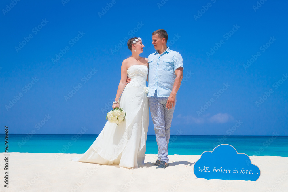 young loving couple on wedding day on tropical sand beach young loving couple on wedding day on tropical sand beach
