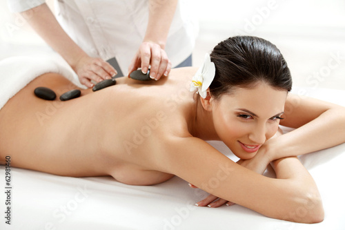 Spa Tretment. Beautiful Woman Getting Spa Hot Stones Massage