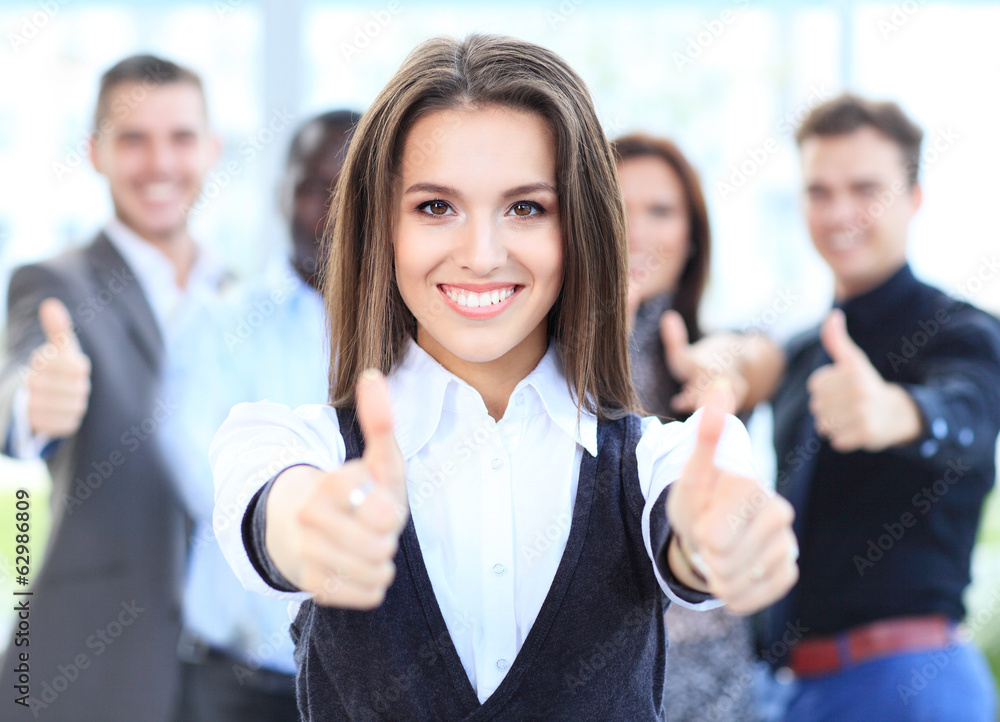attractive businesswoman with team in office showing thumbs up attractive businesswoman with team in office showing thumbs up