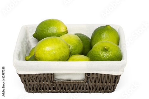  lime fruits inside a wicker basket 