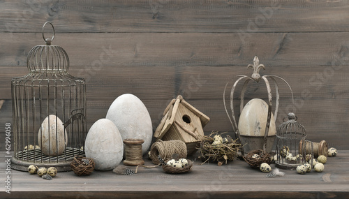 Photography easter decoration with eggs, nest and vintage birdcage