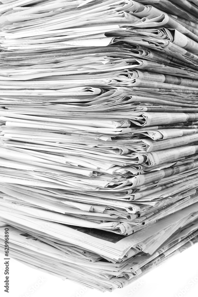 Pile of old newspapers stacked for recycling Pile of old newspapers stacked for recycling