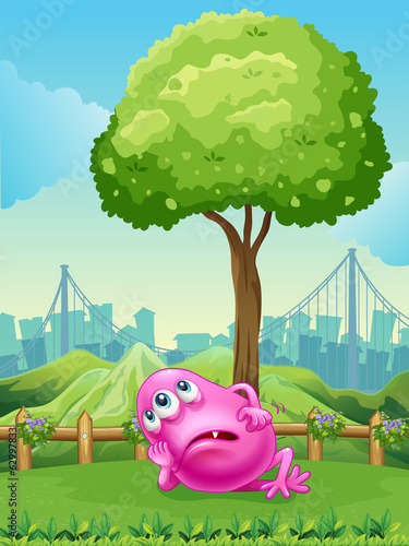 A tired pink monster under the tree