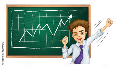 A happy businessman in front of the board