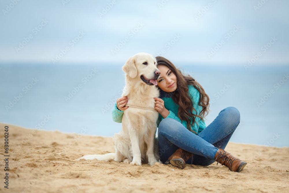 portrait of Beautiful woman with her dog on the beach near sea portrait of Beautiful woman with her dog on the beach near sea