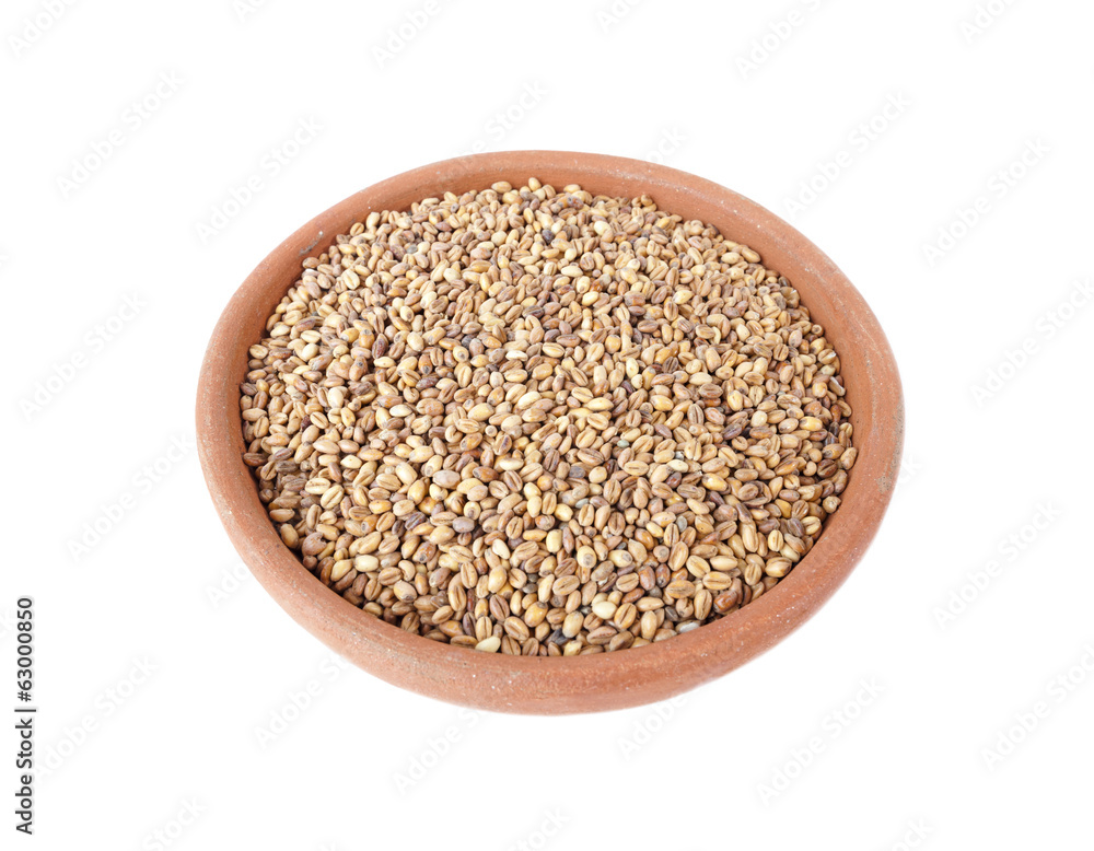 Ground wheat and hemp in bowl of clay on white Ground wheat and hemp in bowl of clay on white