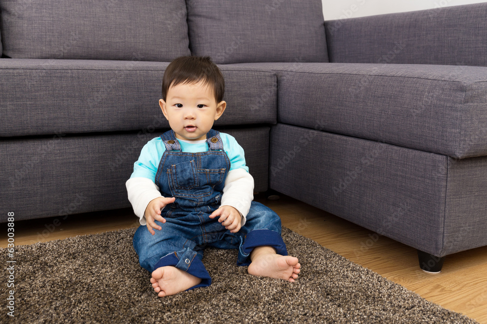 Little boy sitting on carpet Little boy sitting on carpet