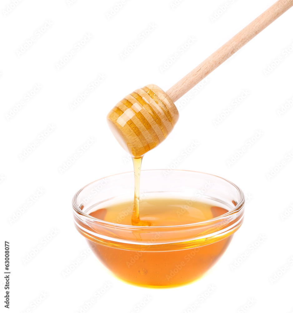 Honey dripping from a wooden dipper Honey dripping from a wooden dipper