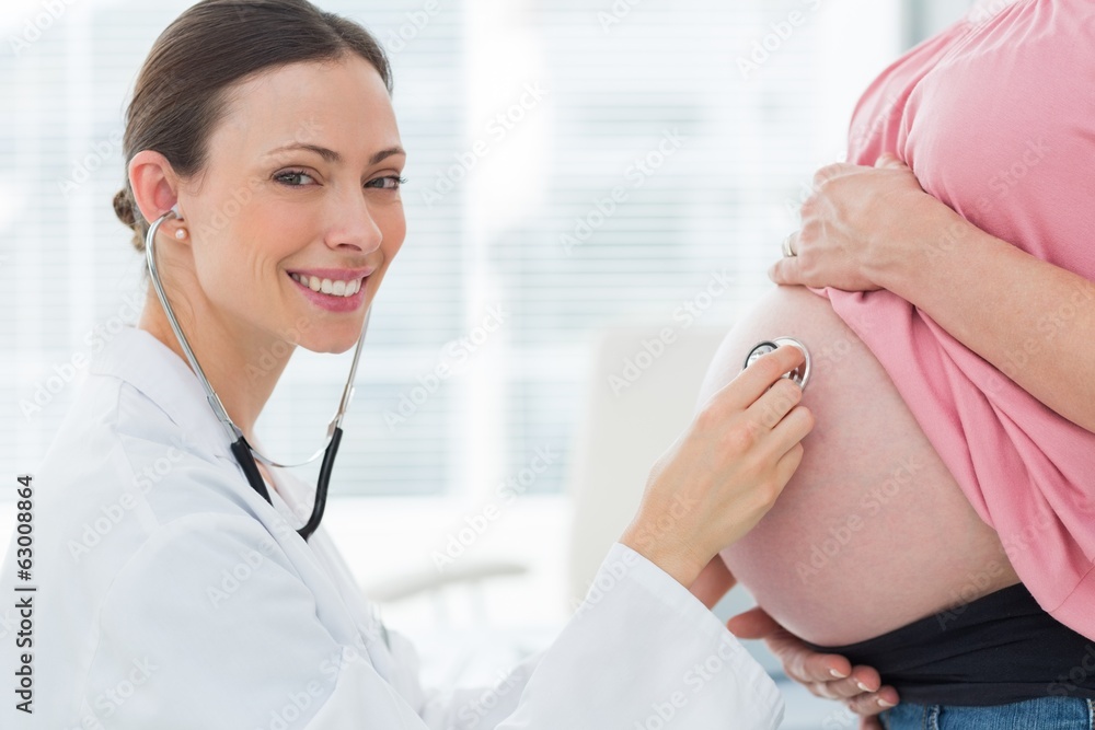 Portrait of doctor checking pregnant woman Portrait of doctor checking pregnant woman