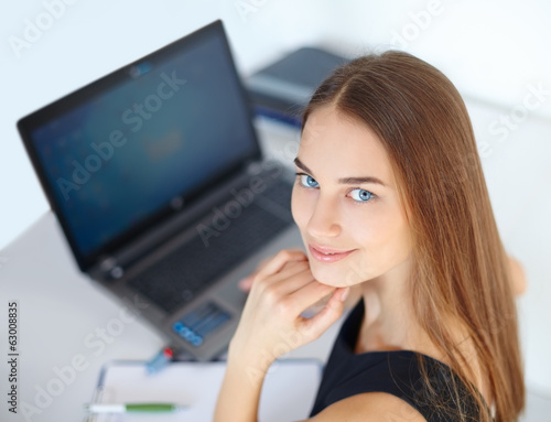 Beautiful young business woman in office
