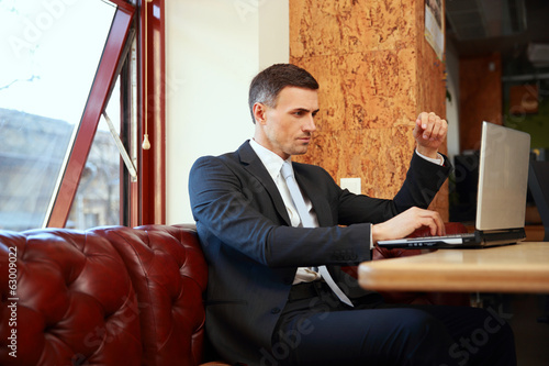 Businessman sitting and using laptop at office