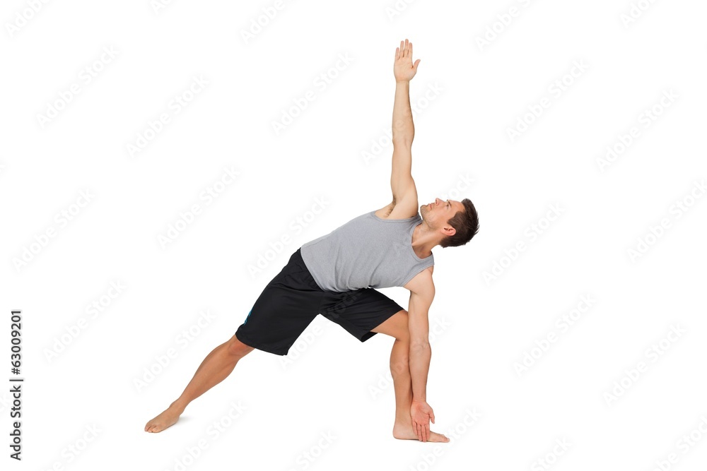 Full length of a young man stretching hand to leg Full length of a young man stretching hand to leg