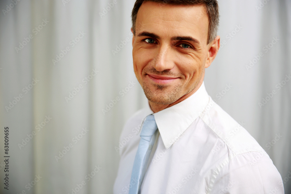 Portrait of a happy handsome businessman in white shirt
