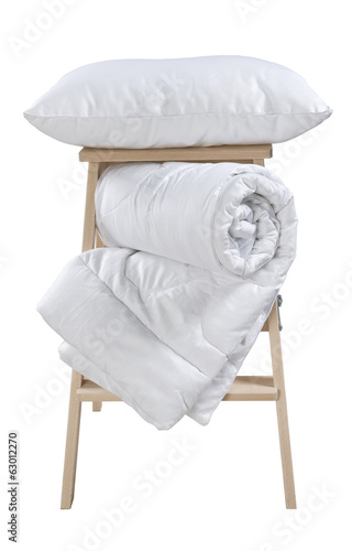 pillow and folded blanket on stepladder